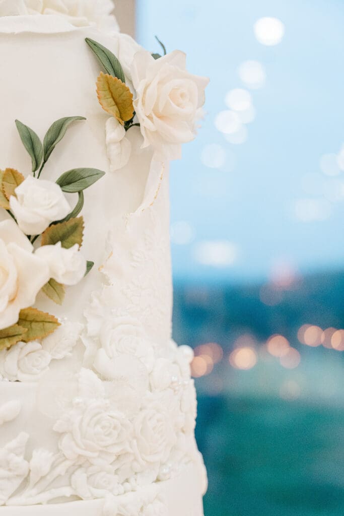 ATL wedding photographer detail of floral wedding cake with sugar roses, fondant lace work, and sugar paste greenery accents.