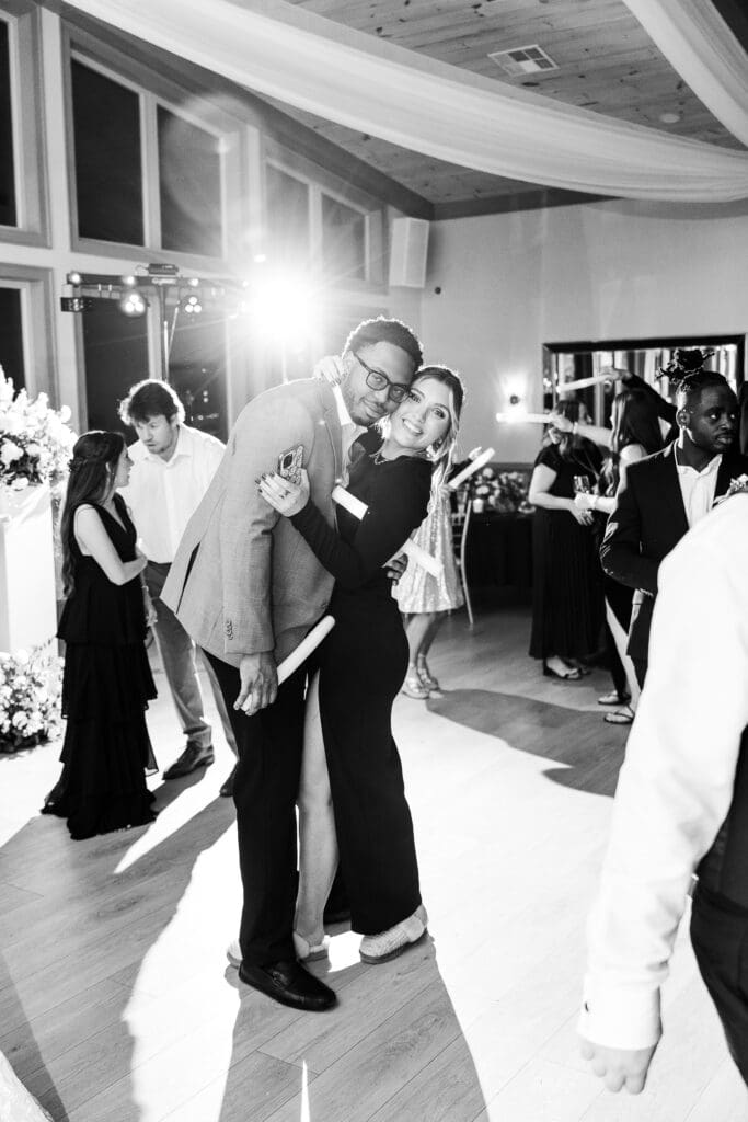 North Georgia wedding photographer captures guests dancing under soft uplighting at elegant indoor venue.